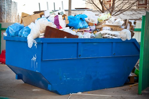 Workers managing builders waste clearance in Millbank
